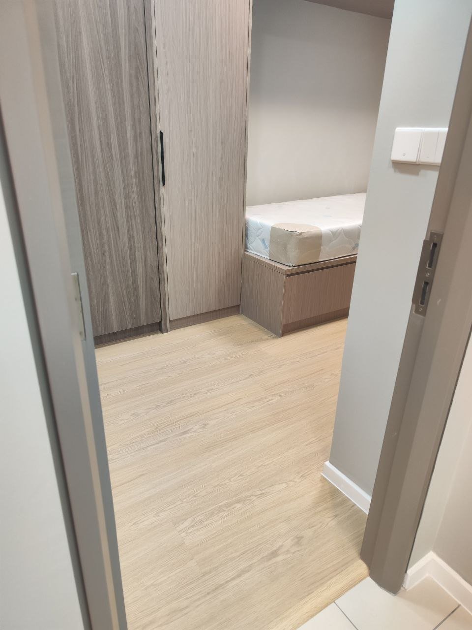 Second bedroom with built-in wardrobe and light oak-look SPC flooring installed in Bloomsvale KL