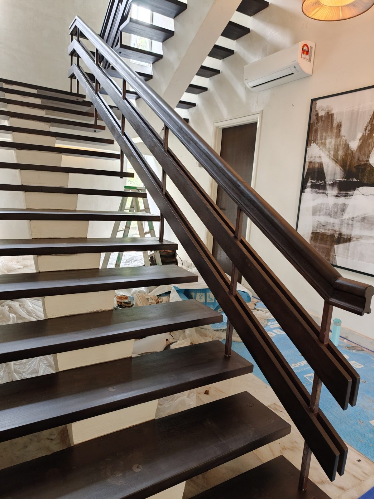 Refinished dark solid timber staircase with matching handrail and balustrade in a Damansara Heights bungalow