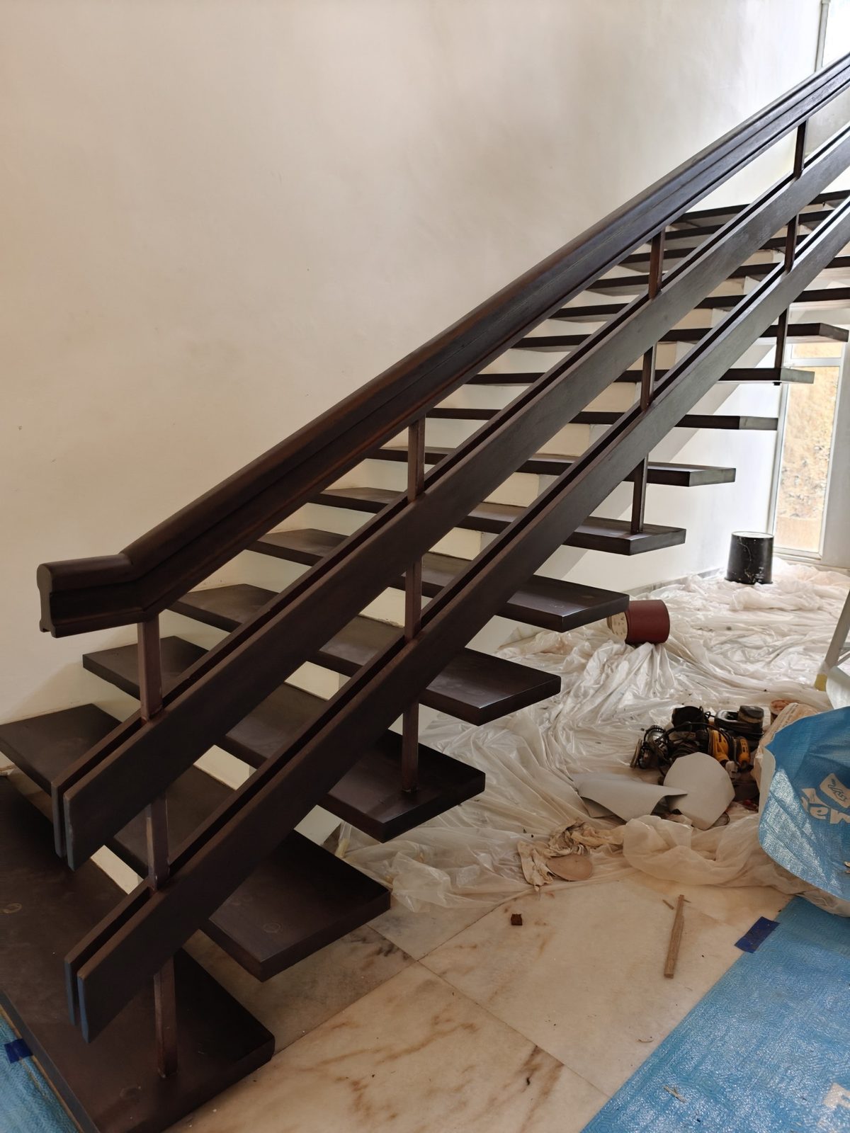 Side view of resanded and revarnished solid timber stair treads and double-rail balustrade in a Damansara Heights bungalow